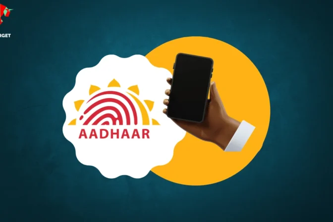 Hand holding a mobile phone with Aadhaar logo on a yellow circle against a teal background.